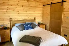 Glamping lodge king size bed and ensuite bathroom