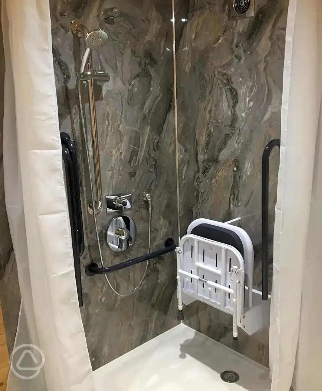 Accessible ensuite shower with seating and grab rails