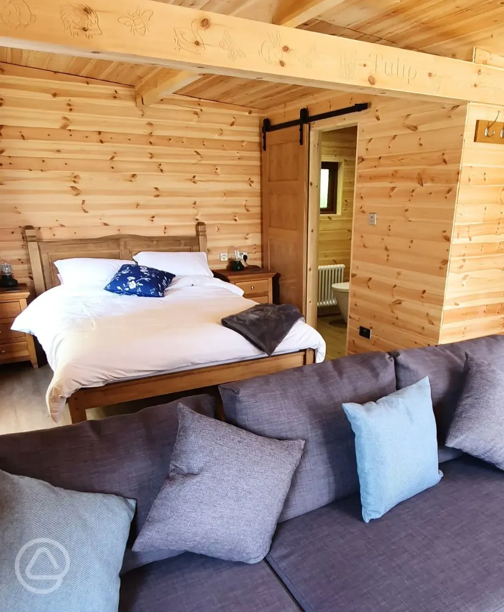 Glamping lodge king size bed and ensuite bathroom
