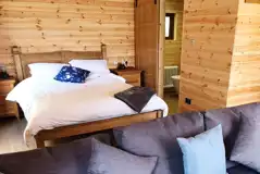 Glamping lodge king size bed and ensuite bathroom