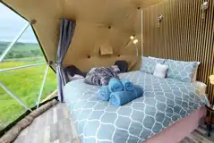 Glamping dome interior with a king size bed (bedding included)