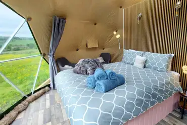 Glamping dome interior with a king size bed (bedding included)