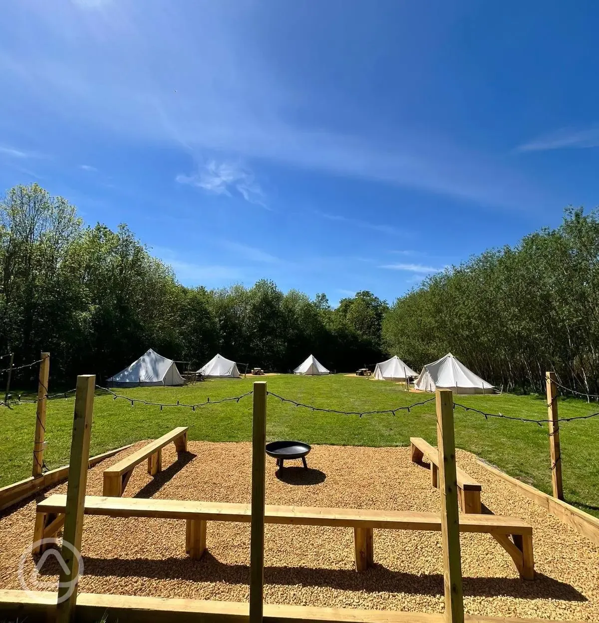 Bell tents and communal fire pit area