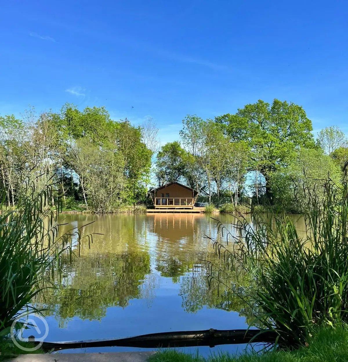 Teal safari tent across the lake