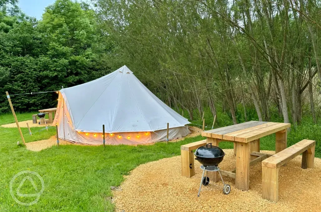 Bell tent with picnic bench and BBQ