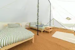 Emperor bell tent with a double bed and two single beds