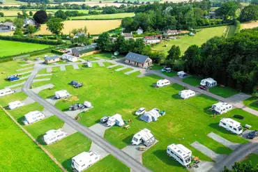 Aerial of Hay-on-Wye Caravan Park with grass and hardstanding pitches