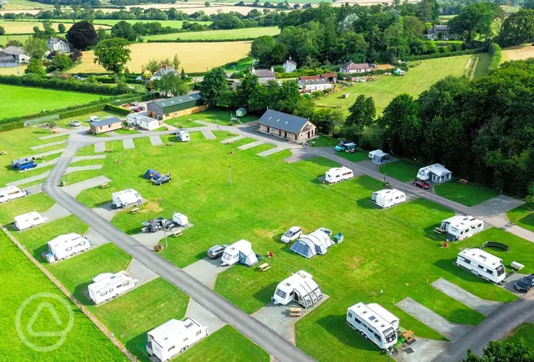 Aerial of Hay-on-Wye Caravan Park with grass and hardstanding pitches
