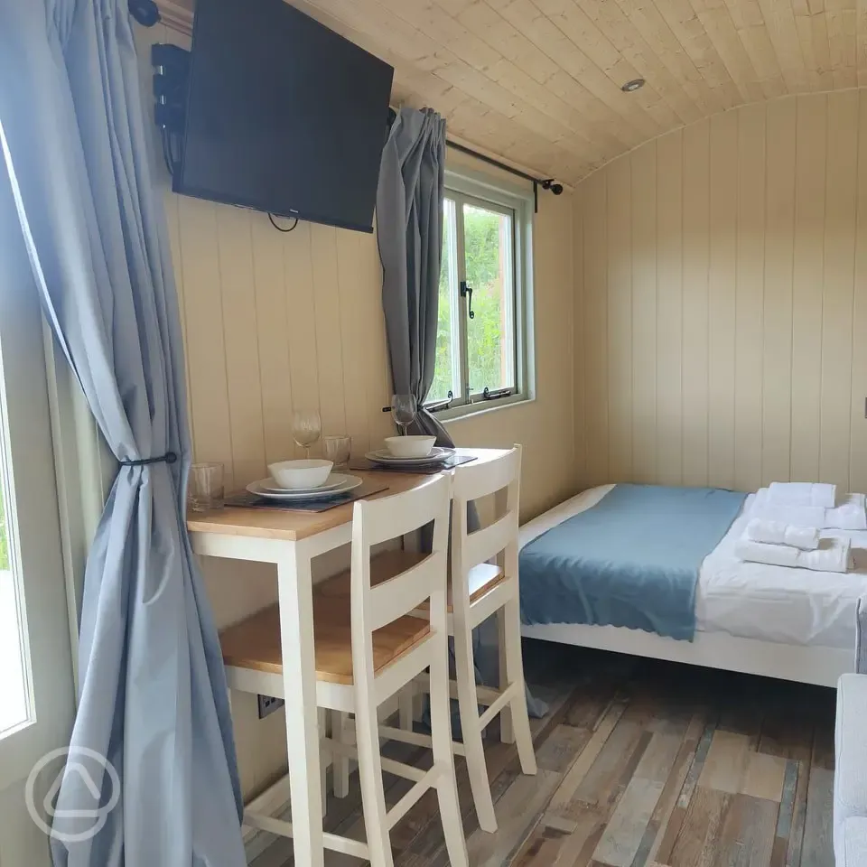 Shepherd's hut dining area and TV