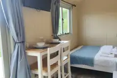 Shepherd's hut dining area and TV