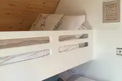 Pod double bed with a single bunk and bedding