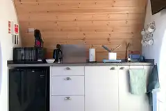 Pod kitchen with a hob, fridge, microwave, kettle, coffee maker, toaster