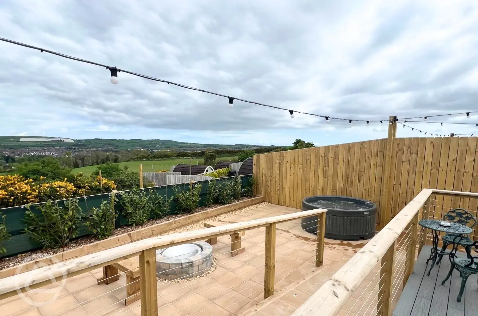 Bumble glamping pod outdoor area and hot tub