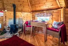 Cabin of Hearts interior with dining area, fire pit, and soft furnishings
