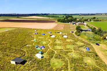 Aerial of Hatters Meadow with grass pitches and glamping