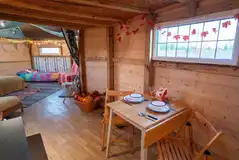 Wandlebury Timber Tent Timber tent dining area with tables and chairs