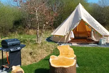 Bell tent with outdoor seating and a gas BBQ