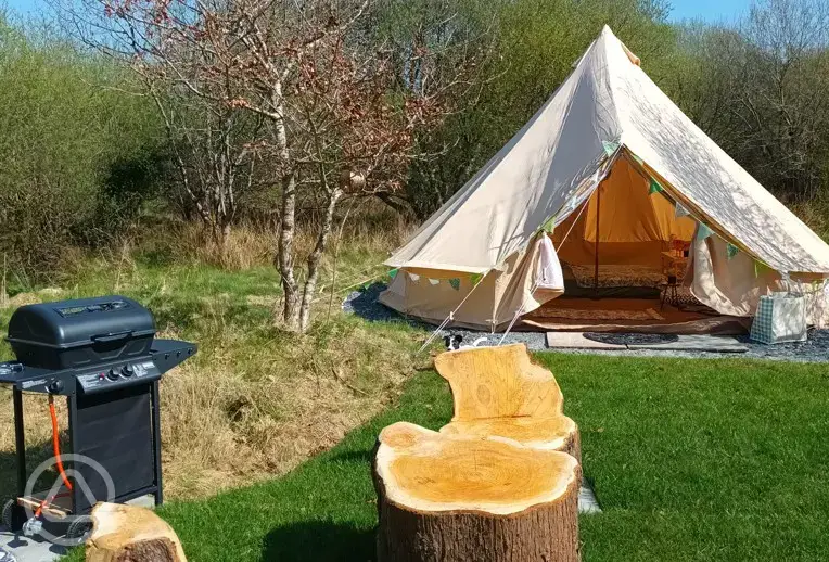 Bell tent with outdoor seating and a gas BBQ