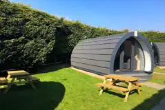 Ensuite glamping pod exterior with benches