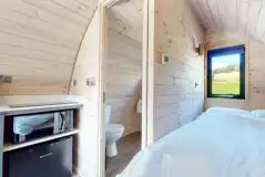 Ensuite glamping pod double bed and ensuite bathroom