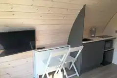 Ensuite glamping pod kitchenette, dining seating and Smart TV