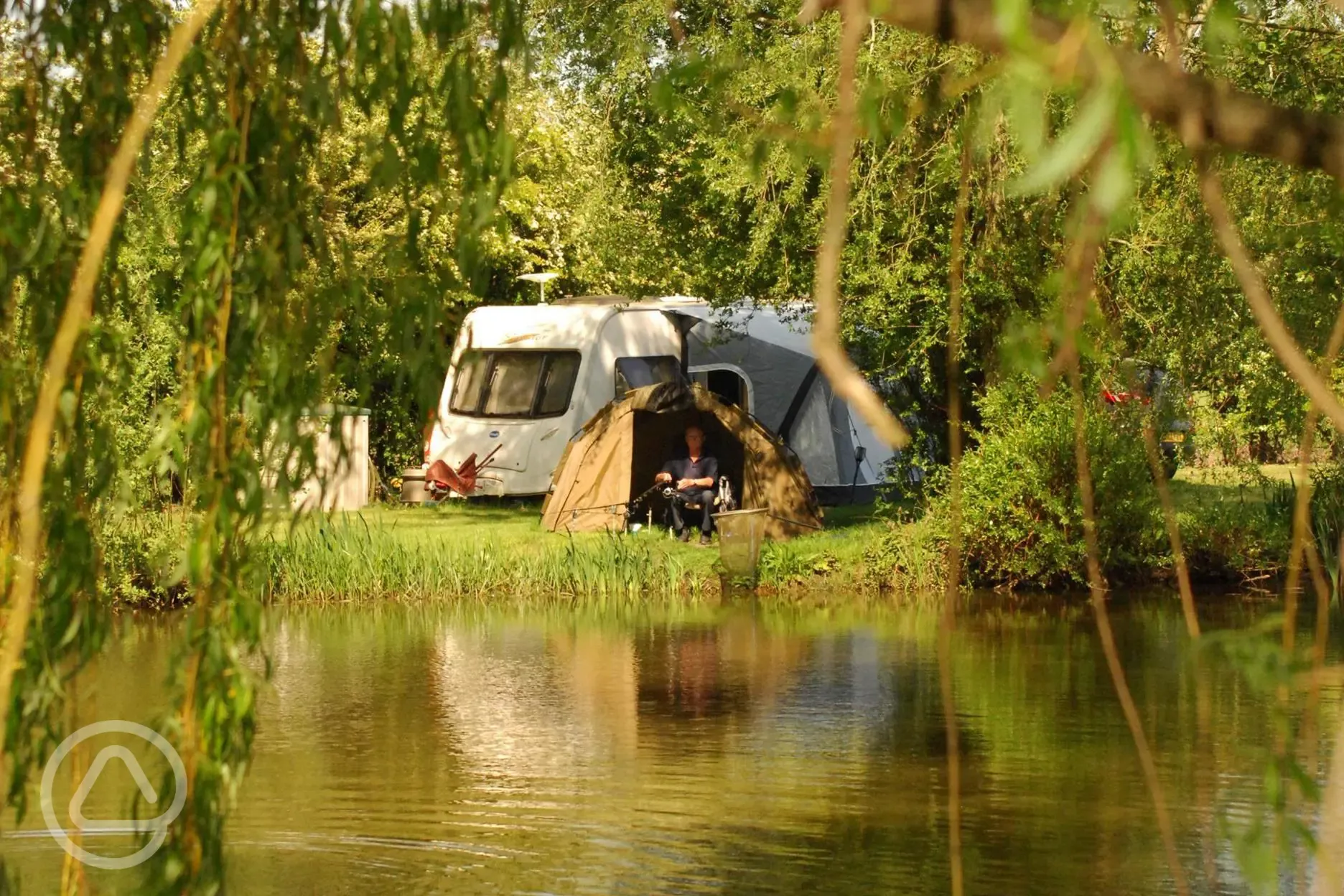 Grass pitches by the fishing lake