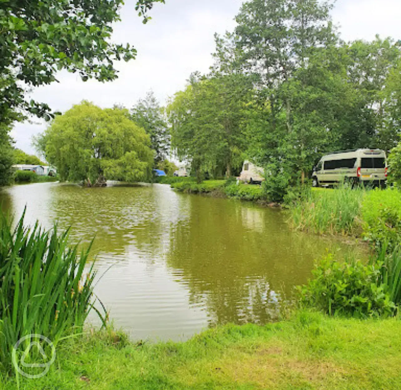 Grass pitches by the fishing lake