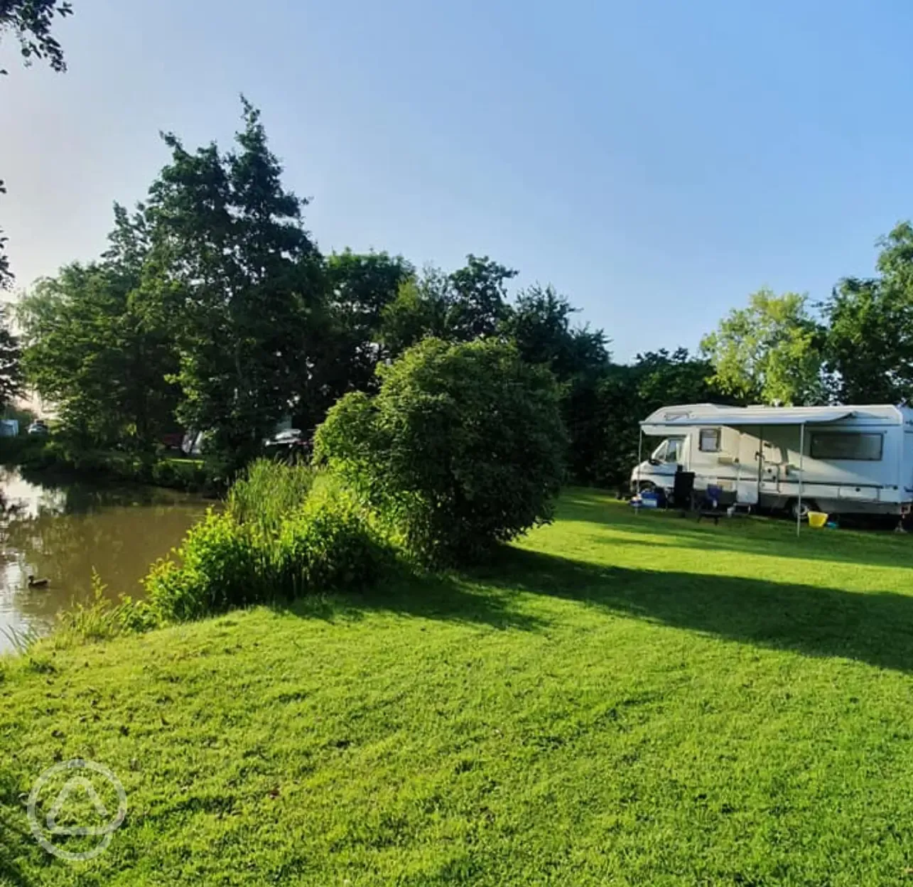 Grass pitches by the fishing lake