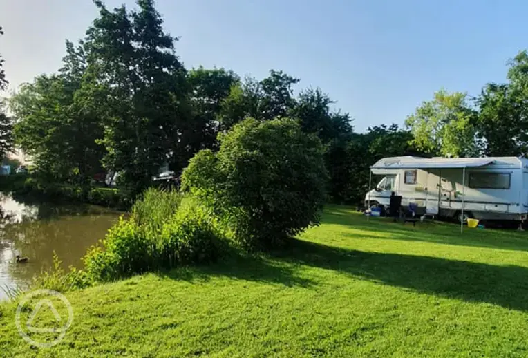 Grass pitches by the fishing lake
