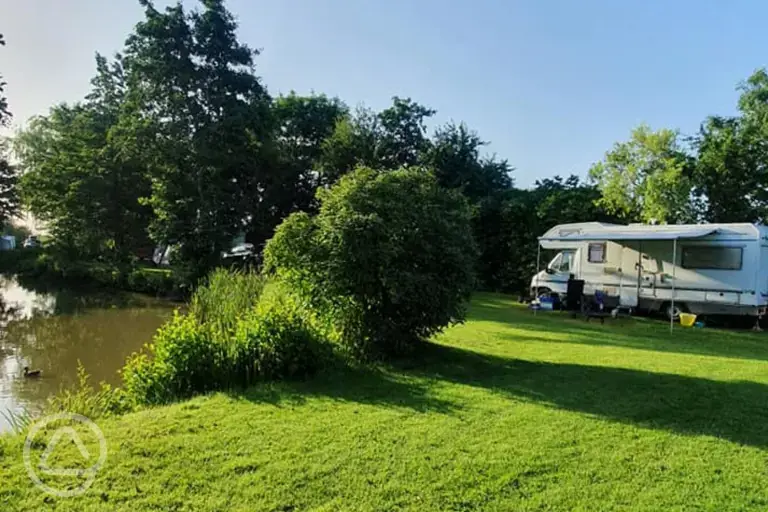 Grass pitches by the fishing lake
