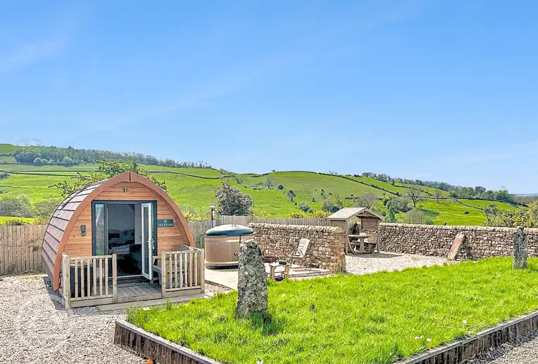 Glamping pod with hot tub and private seating area at Gillcumber Pods