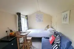 Blue Door glamping cabin double bed and sofa (bedding provided) Blue Door glamping cabin double bed and sofa (bedding provided)