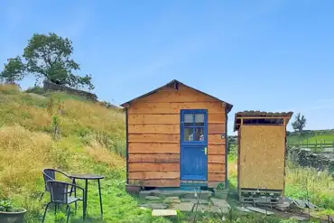 Blue Door glamping cabin exterior with outdoor furniture and private eco loo