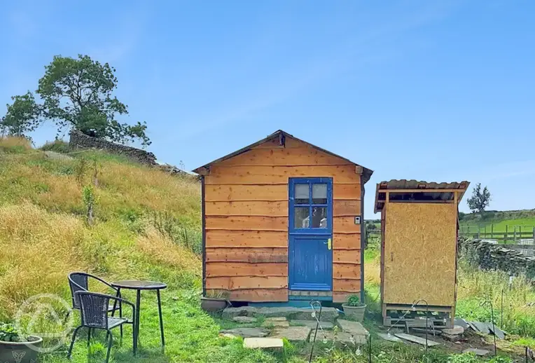 Blue Door glamping cabin exterior with outdoor furniture and private eco loo