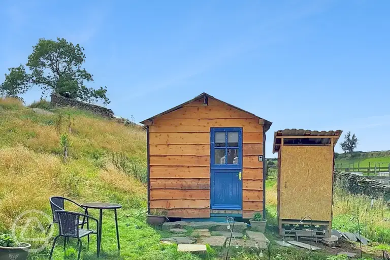 Blue Door glamping cabin exterior with outdoor furniture and private eco loo