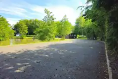 Electric hardstanding pitches with lakeside views and facility block Electric hardstanding pitches with lakeside views and facility block