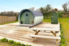 Camping pod with a private toilet hut and decking area Camping pod with a private toilet hut and decking area