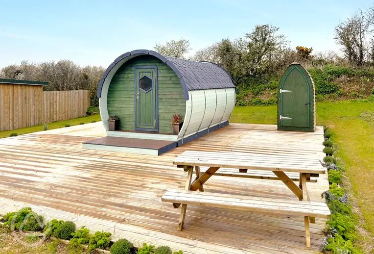 Camping pod with a private toilet hut and decking area