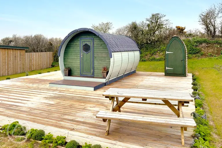 Camping pod with a private toilet hut and decking area