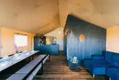 XL safari lodge interior with a dining area, sofa bed, and kitchenette XL safari lodge interior with a dining area, sofa bed, and kitchenette