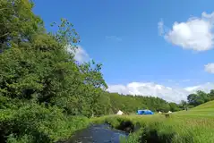 By the Beck non electric grass pitches with waterside views By the Beck non electric grass pitches with waterside views