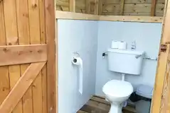 By the Beck pitches and the bell tents each have a private toilet hut By the Beck pitches and the bell tents each have a private toilet hut