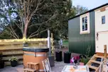 Skyland shepherd's hut with a wood-fired hot tub, fire pit and patio
