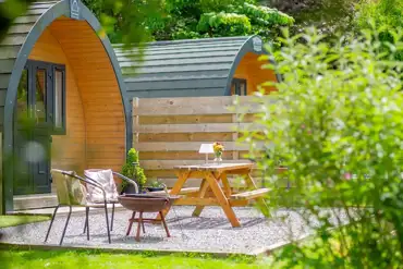 Glamping pods with private patios, fire pits and wood-fired hot tubs