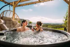 Private patios with hot tubs and cocoon swing chairs