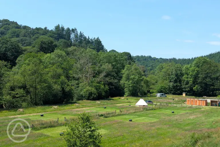 Overview of Lake Vyrnwy Campsite, surrounded by trees
