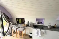 Glamping pod kitchen, breakfast bar and TV Glamping pod kitchen, breakfast bar and TV