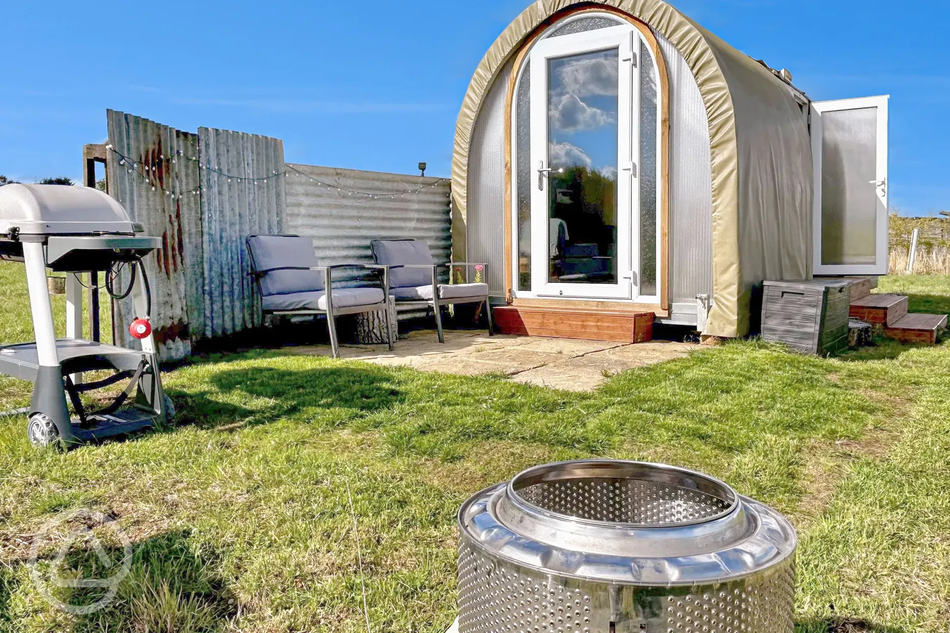 Coco Pod private patio with outdoor seating, fire pit, and BBQ