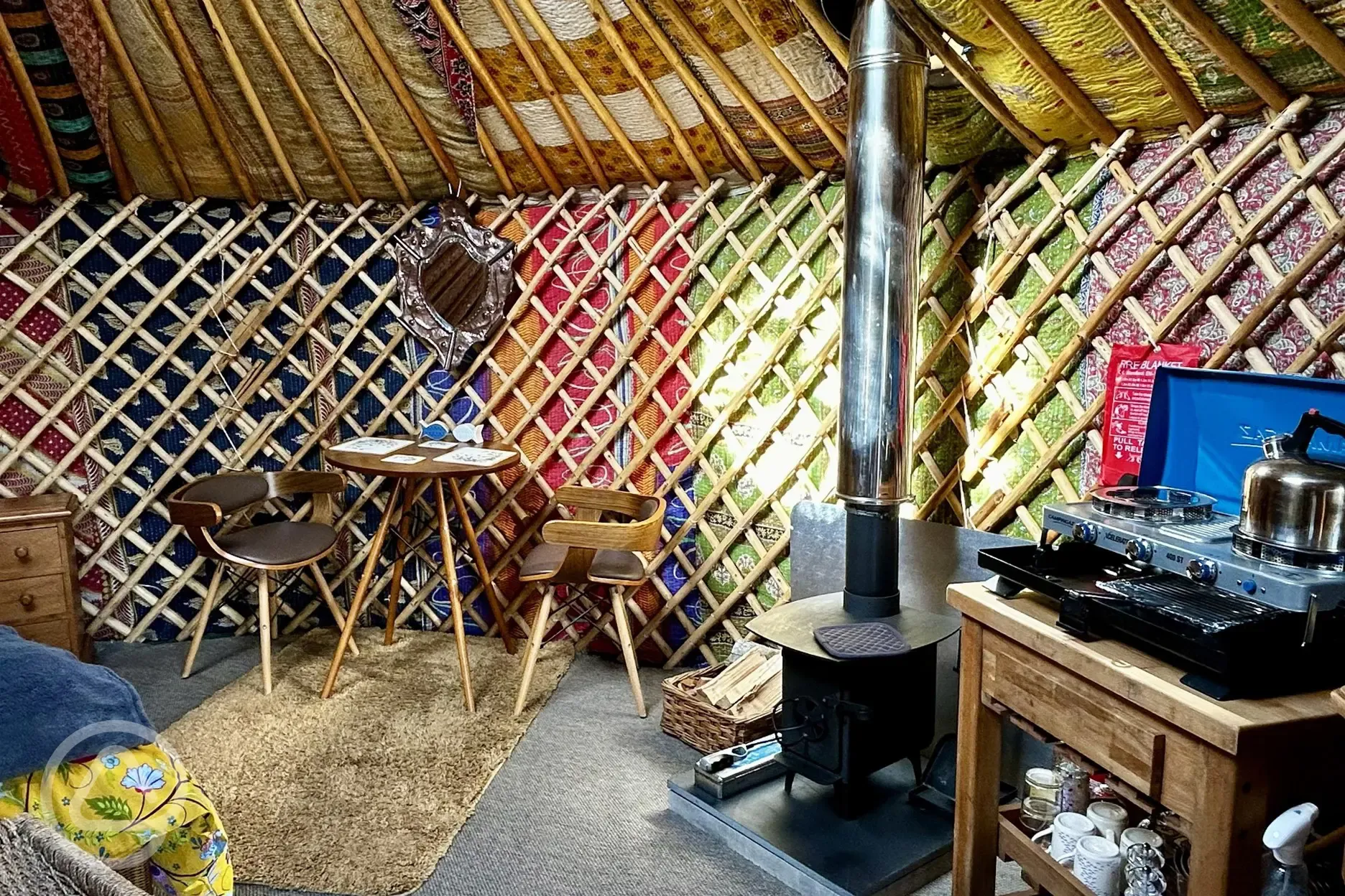 Primrose Yurt dining area and log burner