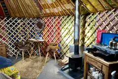 Primrose Yurt dining area and log burner